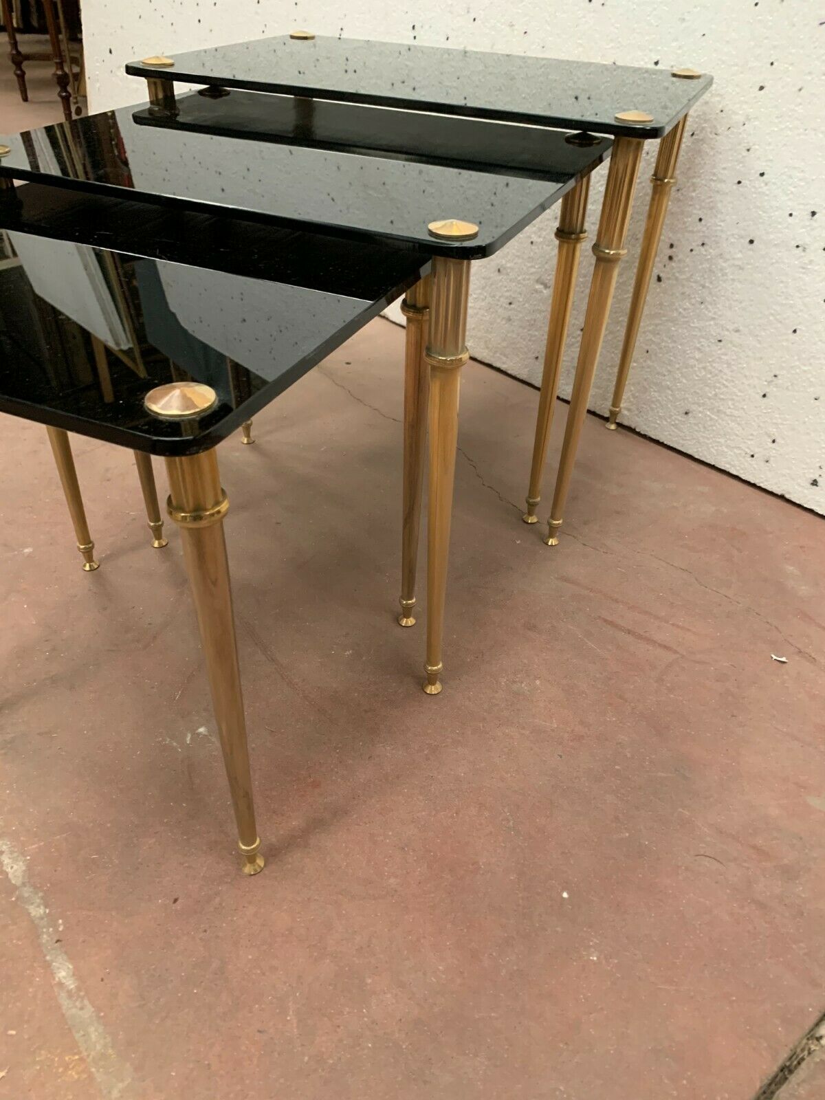Pull out tables in brass and black glass XX century