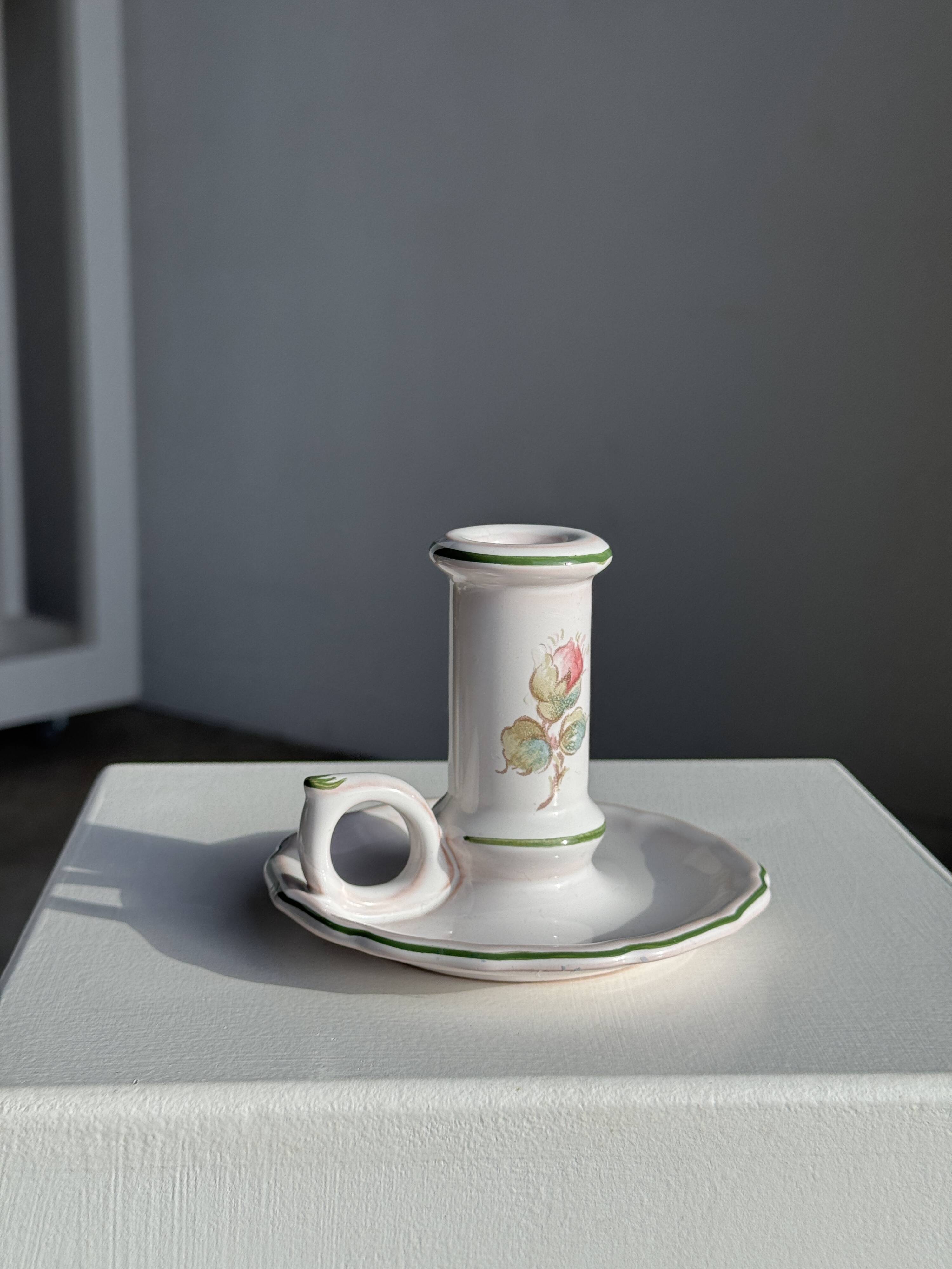 Small vintage hand-held candlestick in earthenware with green trim and floral decoration H10.5