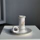 Small vintage hand-held candlestick in earthenware with green trim and floral decoration H10.5