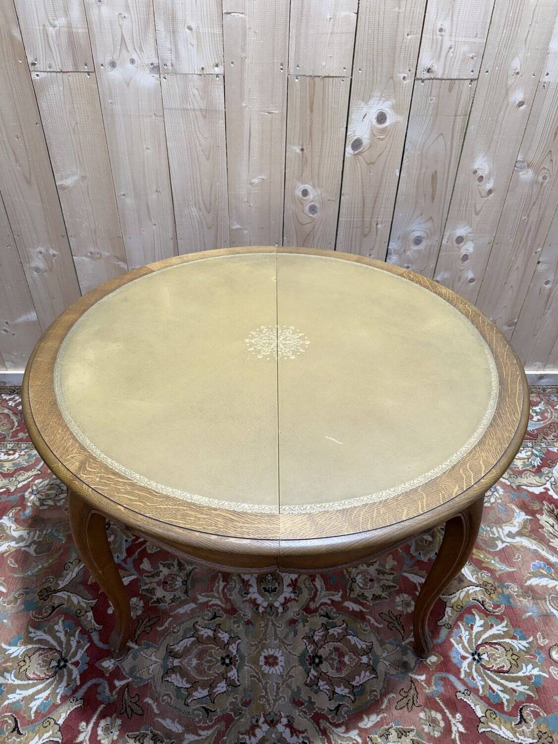 Round oak dining table with leather in Louis XV style.