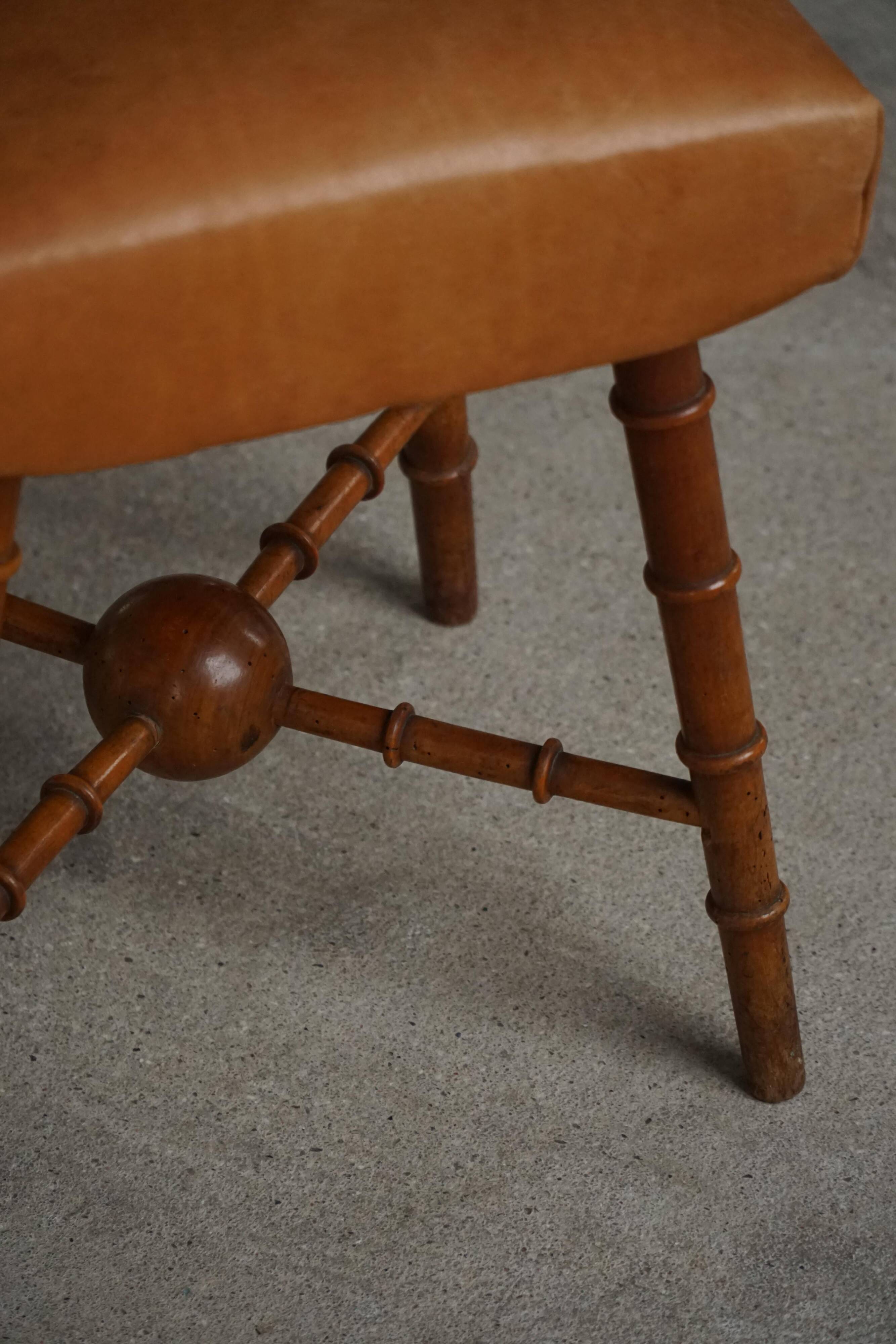 Turned wooden stool with leather seat, mid-20th century, Danish modern.