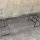 Large vintage industrial glass table with adjustable metal trestles.