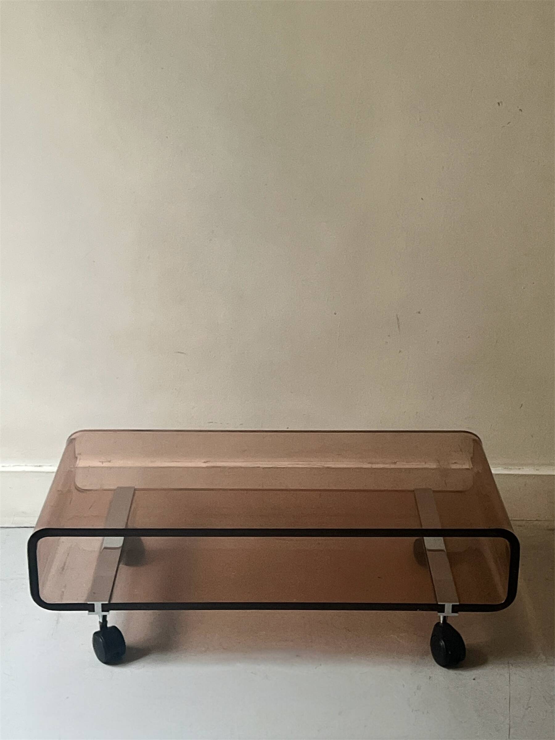 Smoked plexiglass coffee table on wheels, Roche Bobois design 1970.