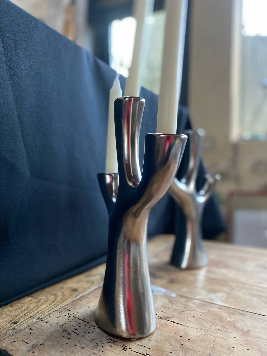 Silver candlesticks in the shape of a 3-branch tree