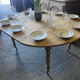 Oval wooden table on wheels.