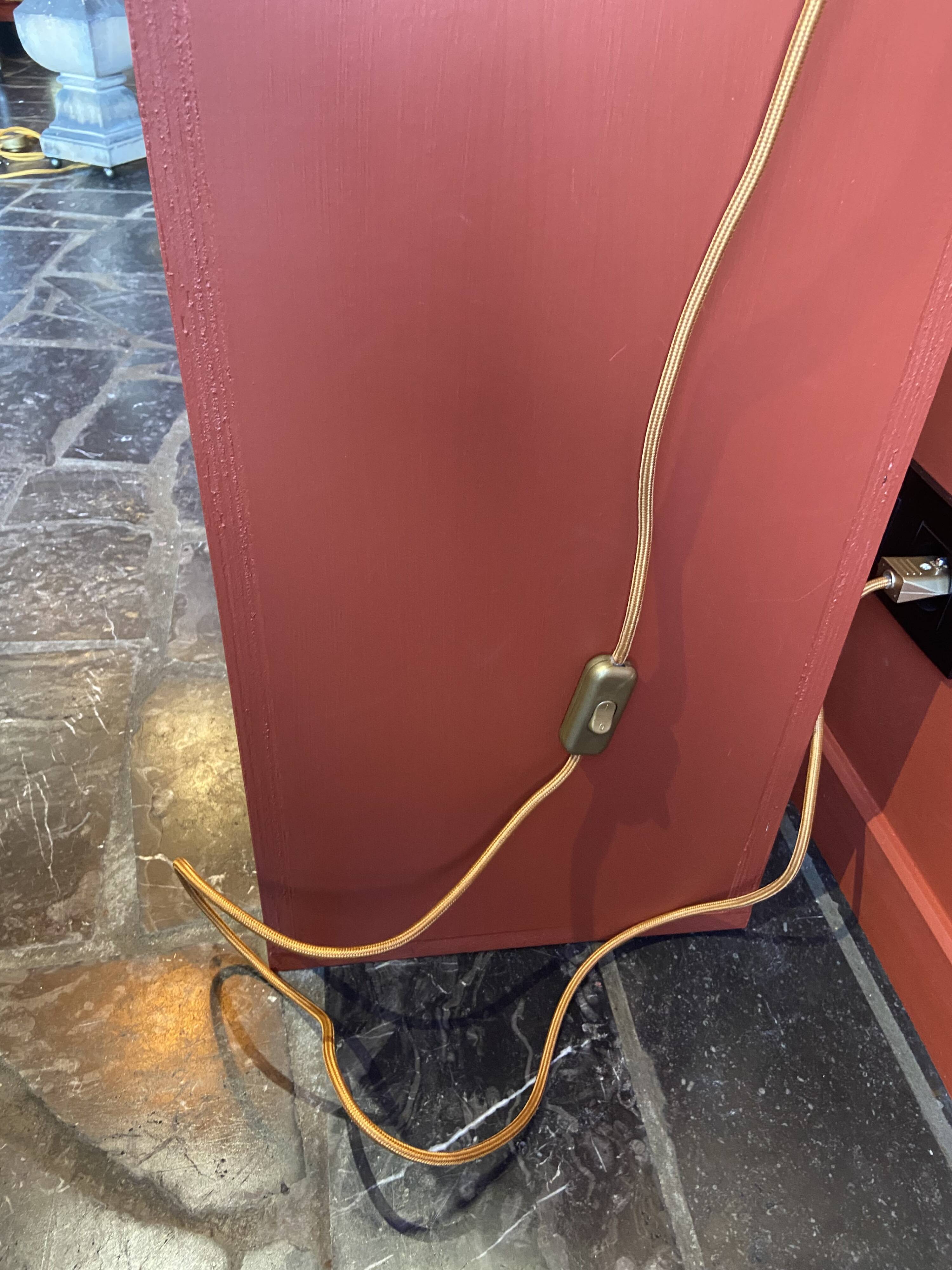 "Stoneware Bottle Lamp" with a multicoloured blue lampshade handwoven in India.