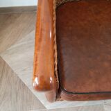 Armchair in woven rattan and exotic wood