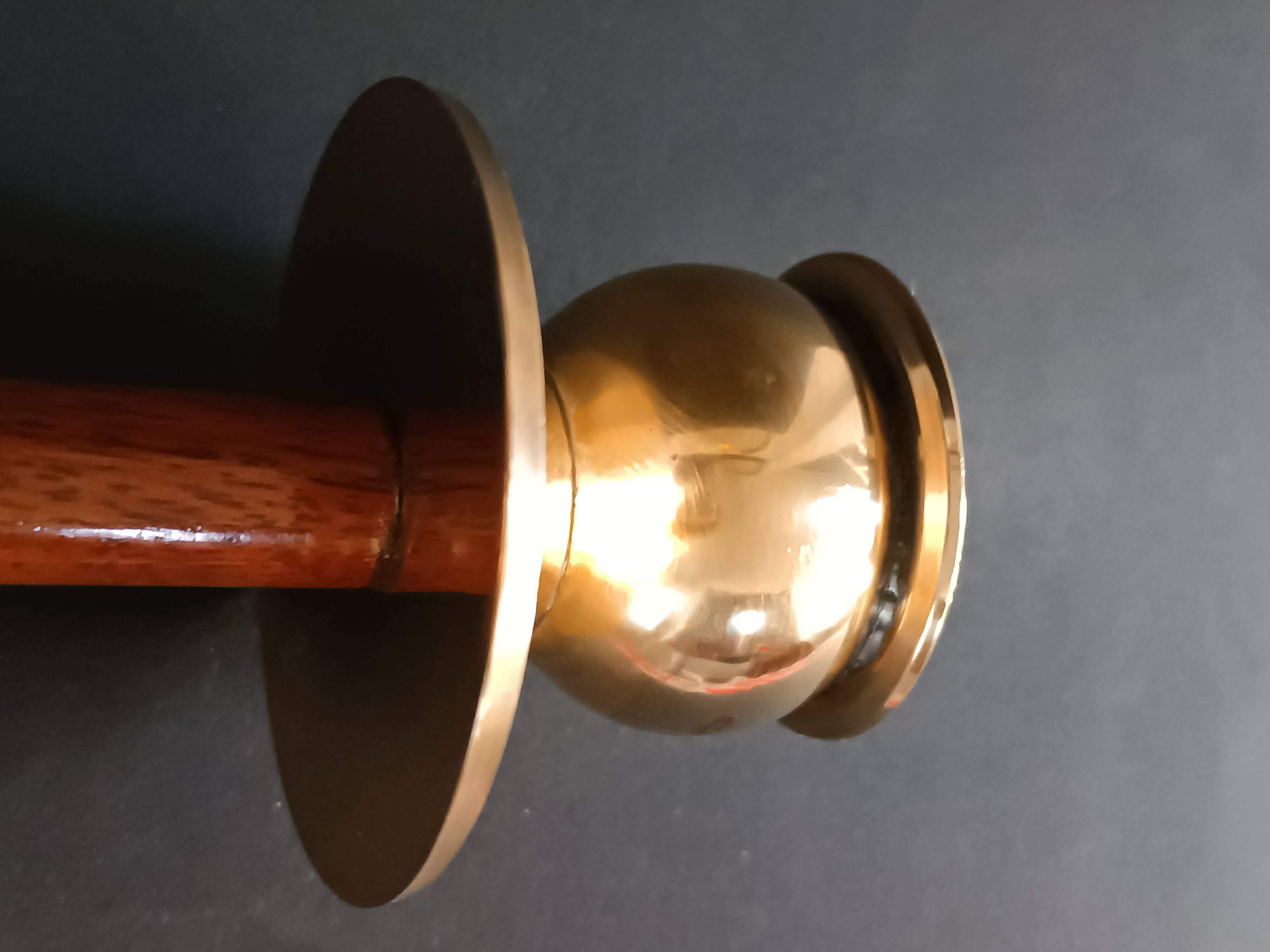 Two vintage wooden and brass candlesticks.