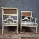 a pair of caned armchairs in the Louis XVI style, elegant and full of charm.