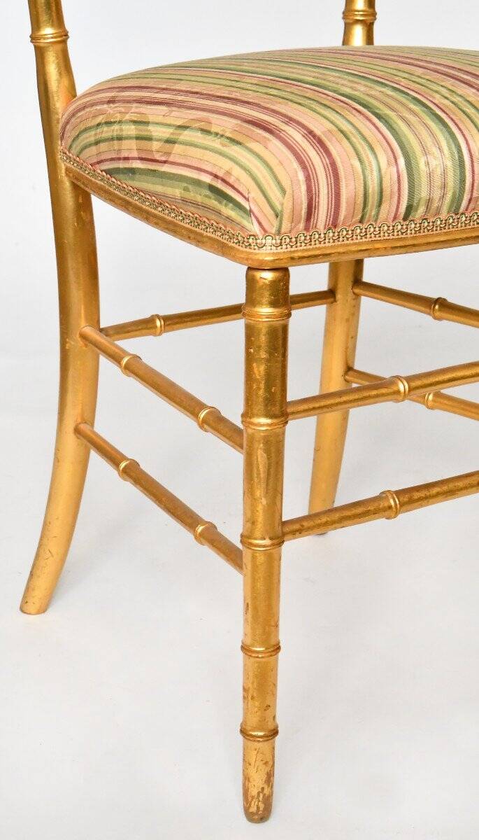 Pair of golden wood chairs in a bamboo style.