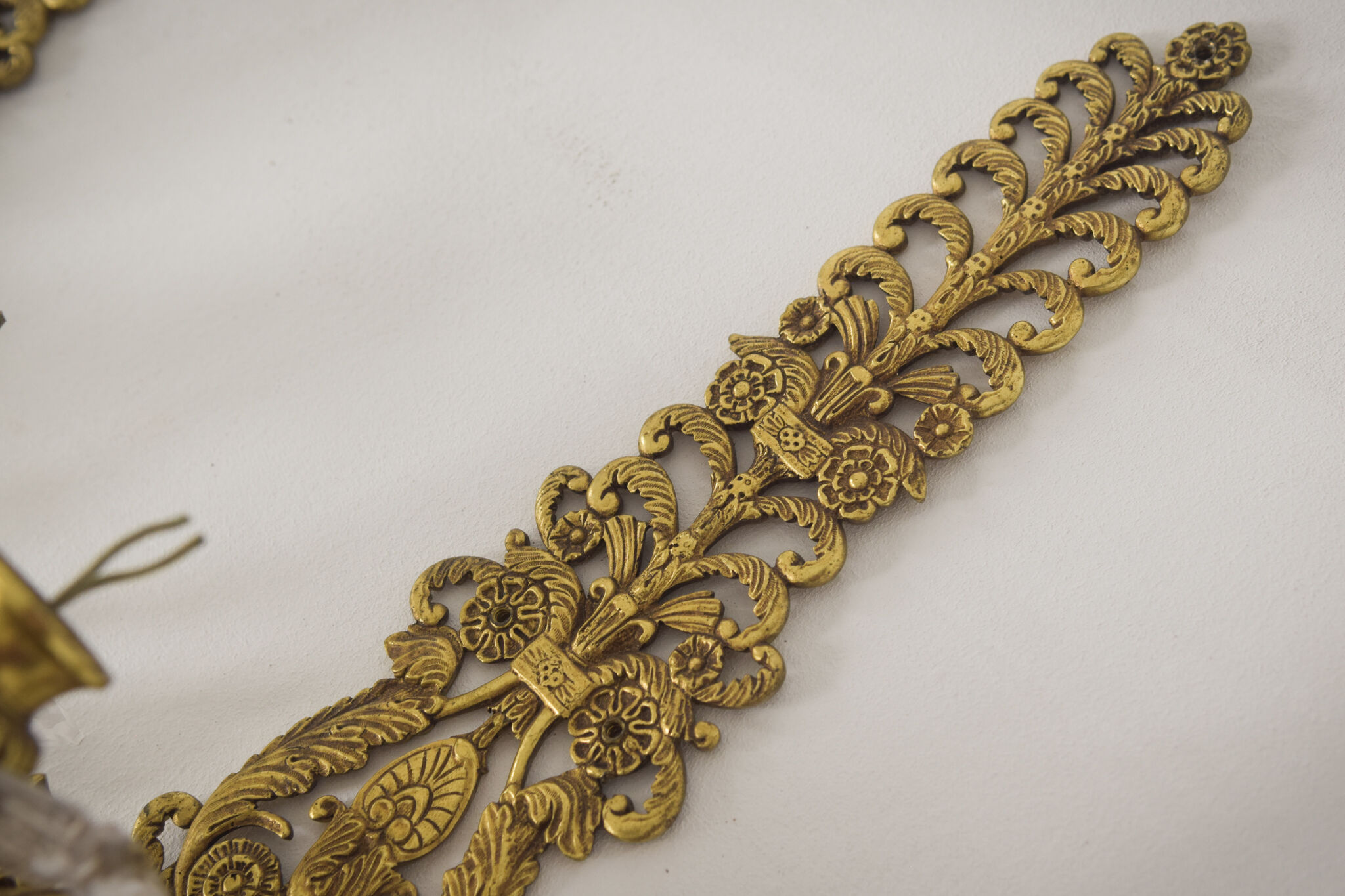 Two bronze and cut glass wall-mounted chandeliers