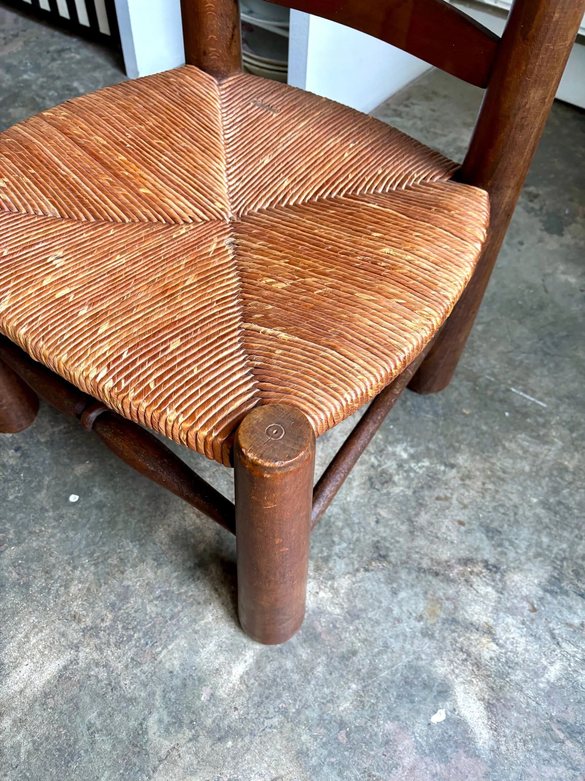 Brutalist low chair in dark wood and straw no. 2