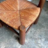 Brutalist low chair in dark wood and straw no. 2