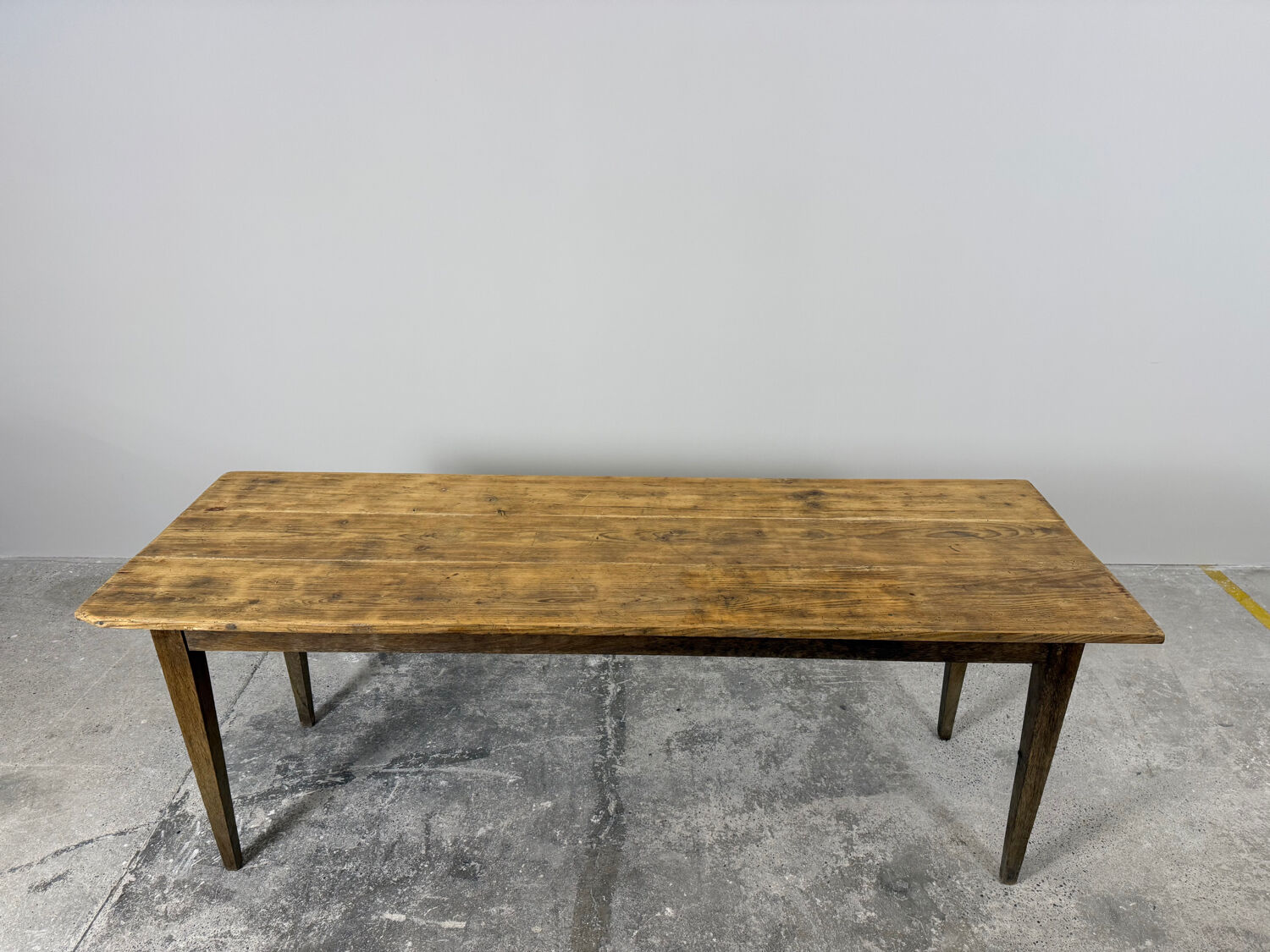 Old farmhouse table with tapered legs, late 19th to early 20th century.