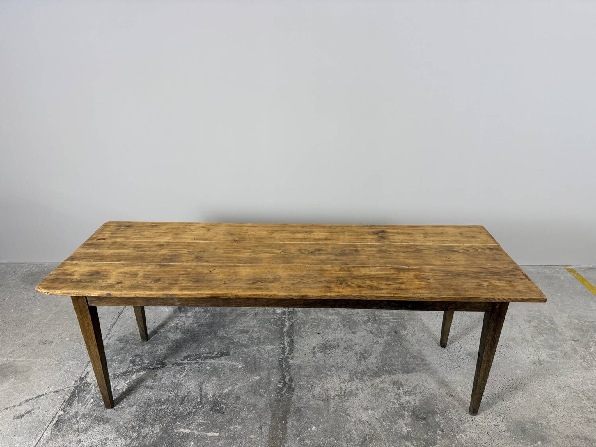 Old farmhouse table with tapered legs, late 19th to early 20th century.