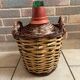 Old glass demijohn with wicker basket.