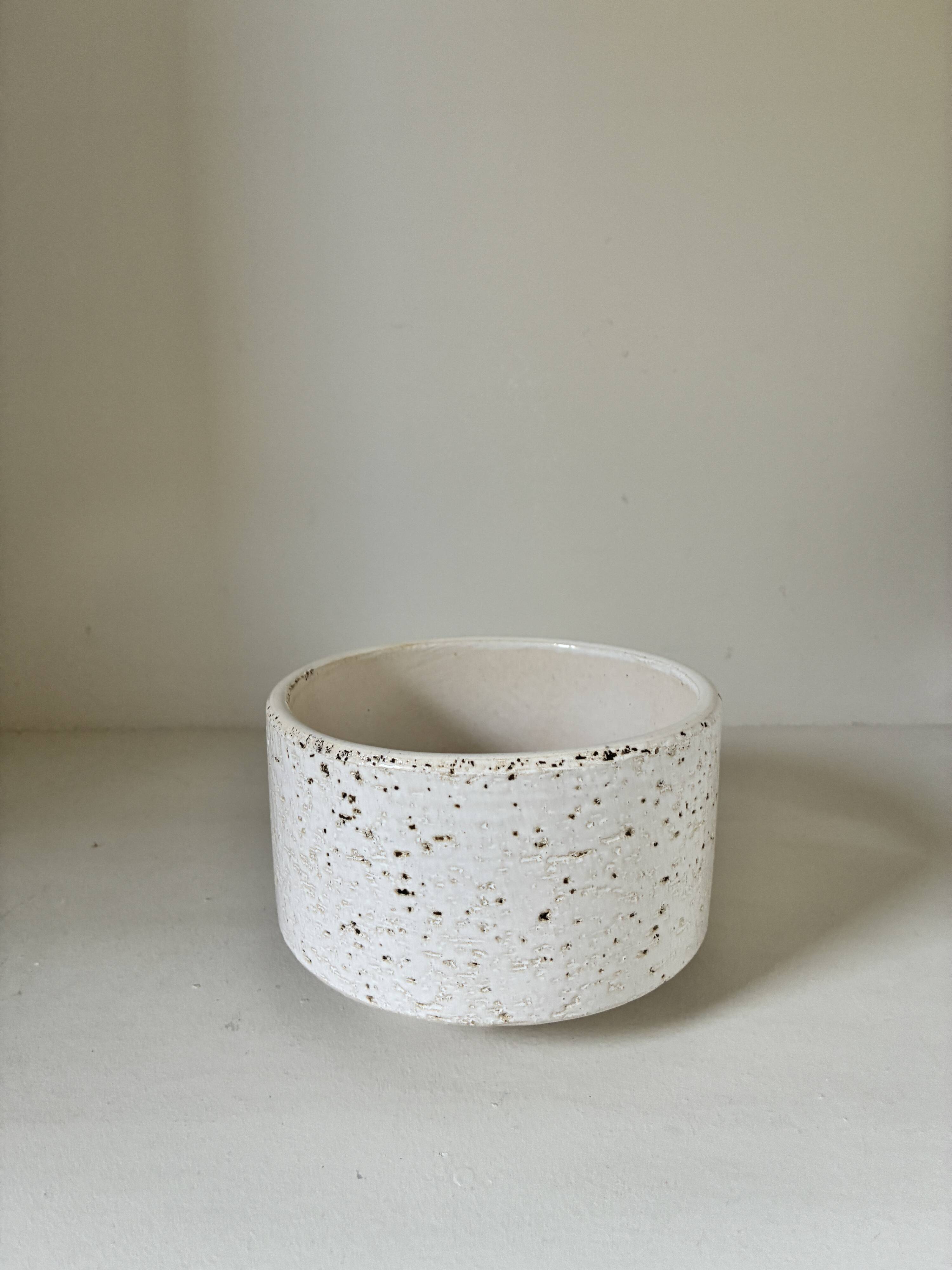 White ceramic vase with a textured effect.
