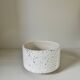 White ceramic vase with a textured effect.