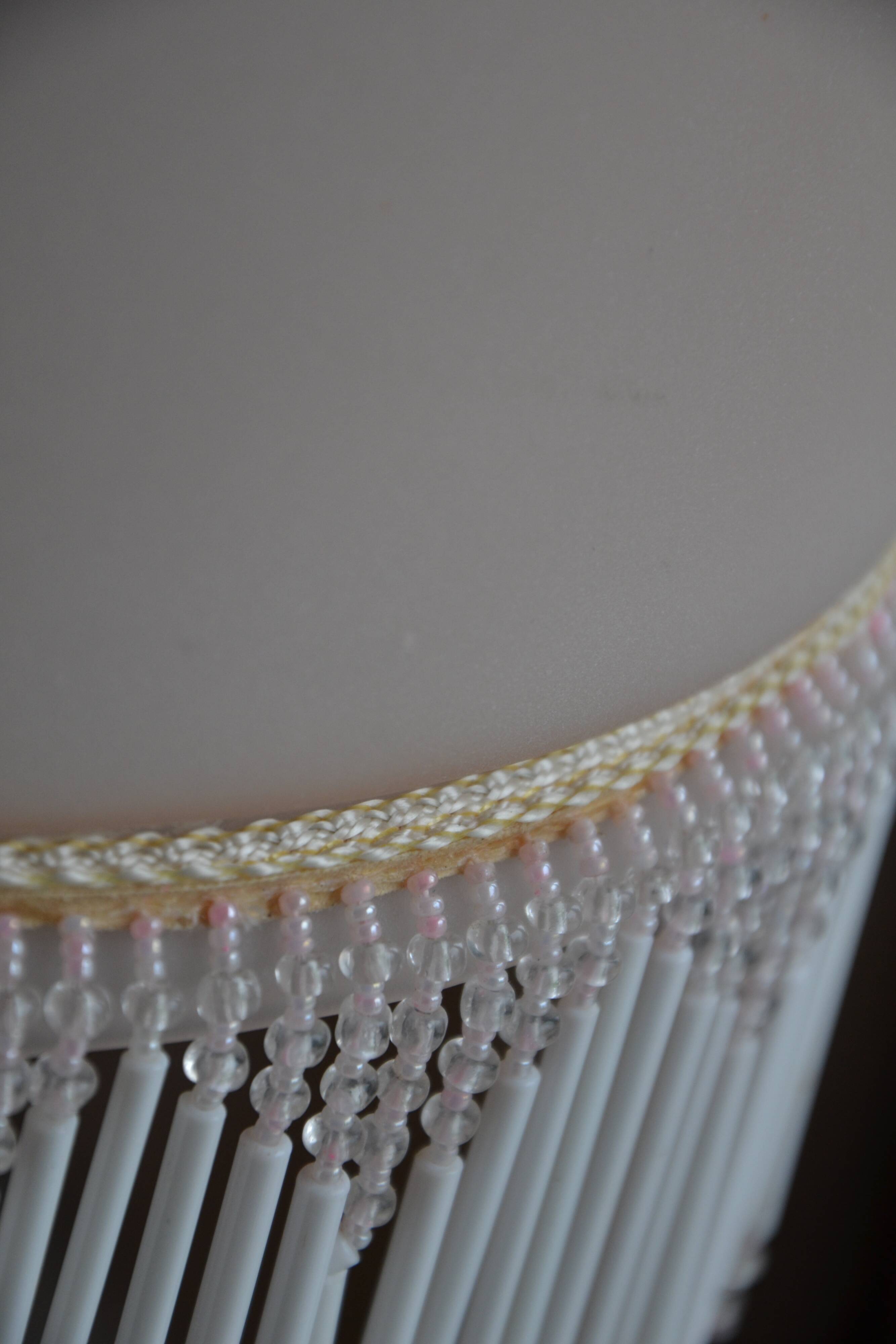 Lustrous suspension in glass paste, glass and ceramic pendants.