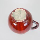 Large red and blue glazed ceramic pitcher signed Delène under the base