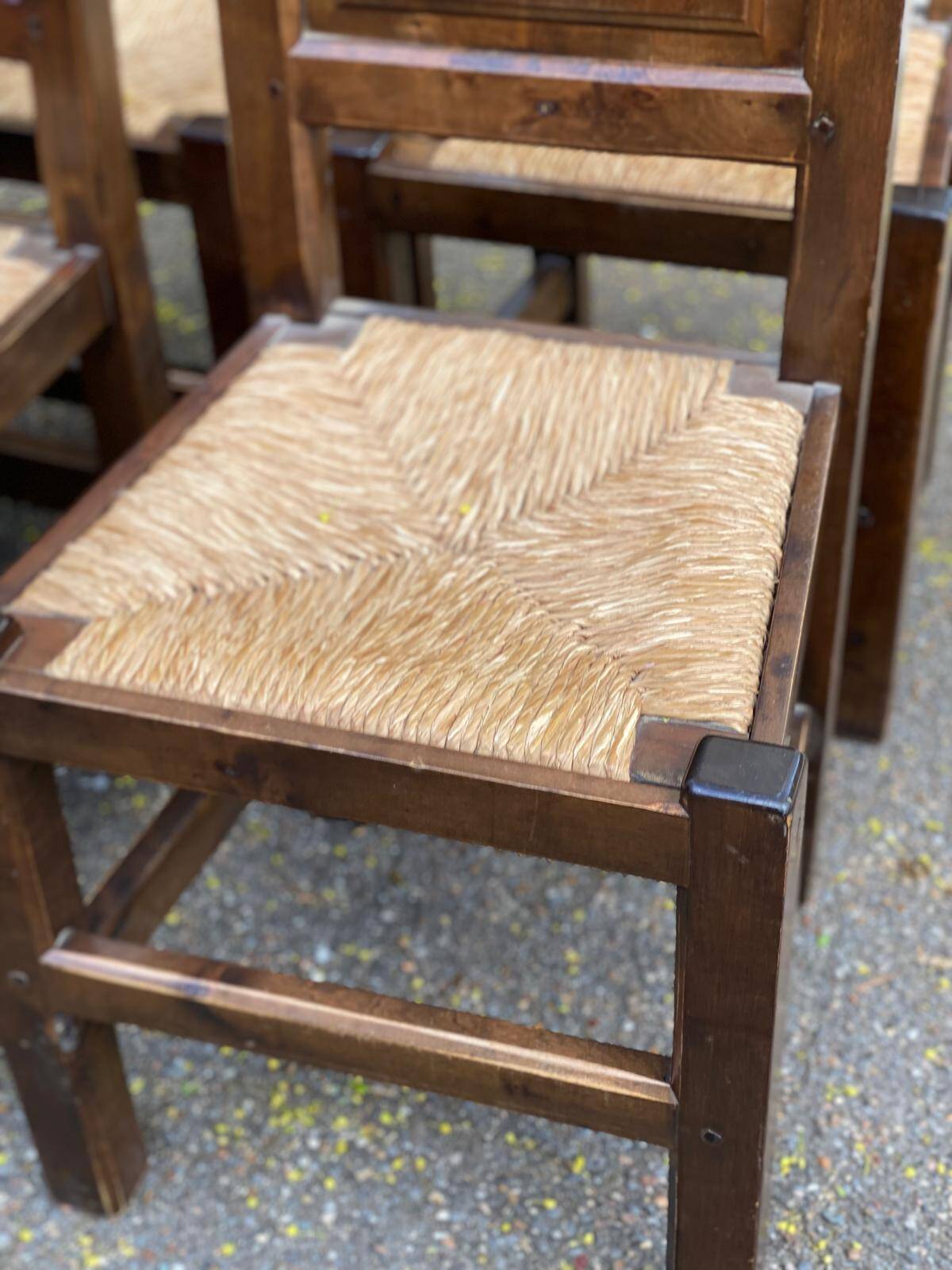 6 dining chairs in a country or farmhouse style, made of dark solid wood and rush-seated.