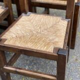 6 dining chairs in a country or farmhouse style, made of dark solid wood and rush-seated.