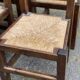 6 dining chairs in a country or farmhouse style, made of dark solid wood and rush-seated.