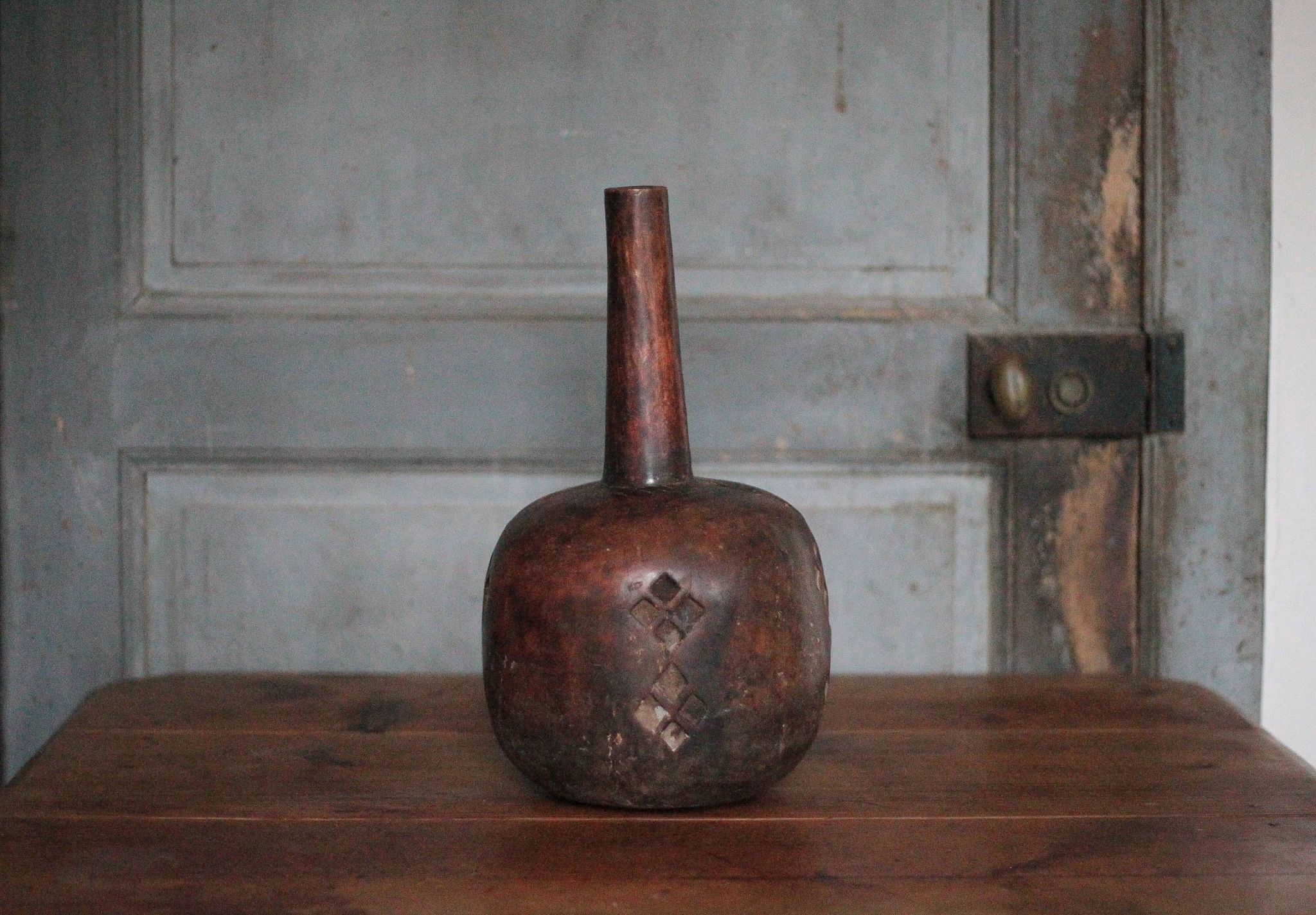 Vintage African wooden carved gourd bottle.