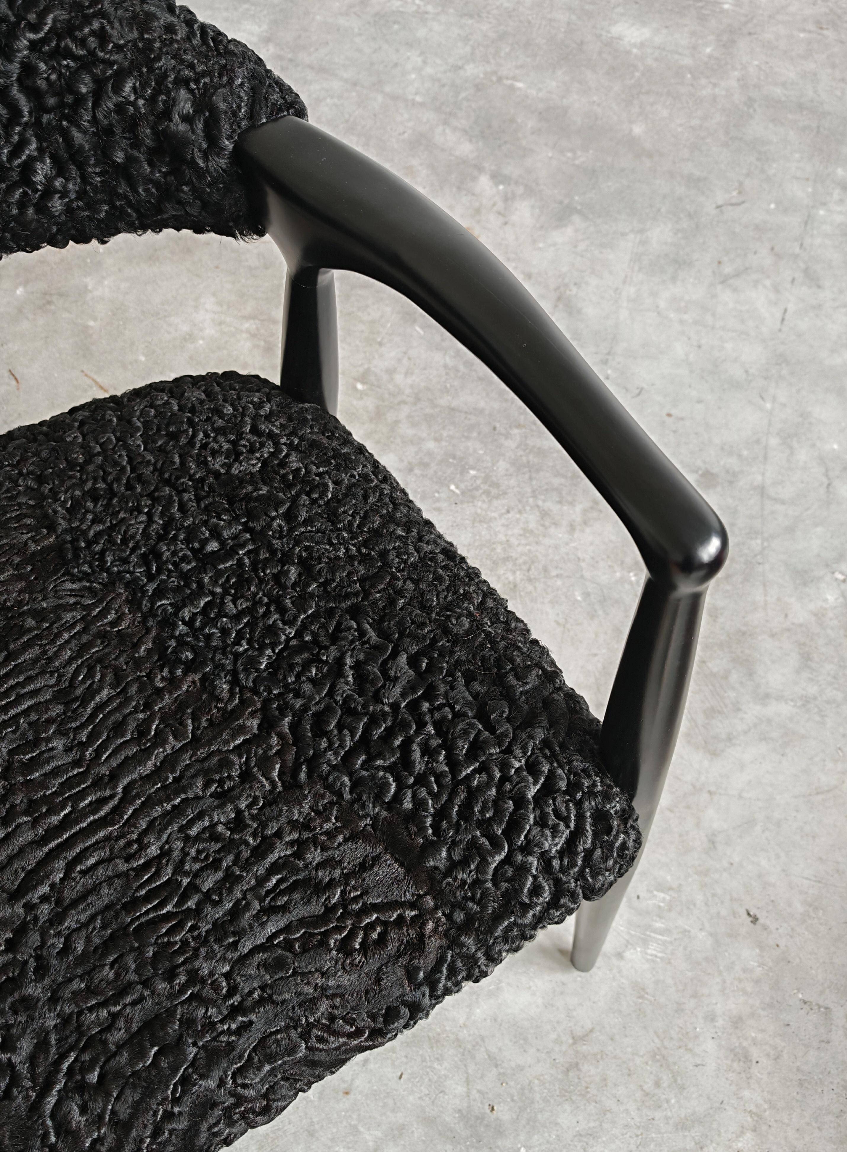 Pair of Mid Century Modern armchairs in astrakhan leather.