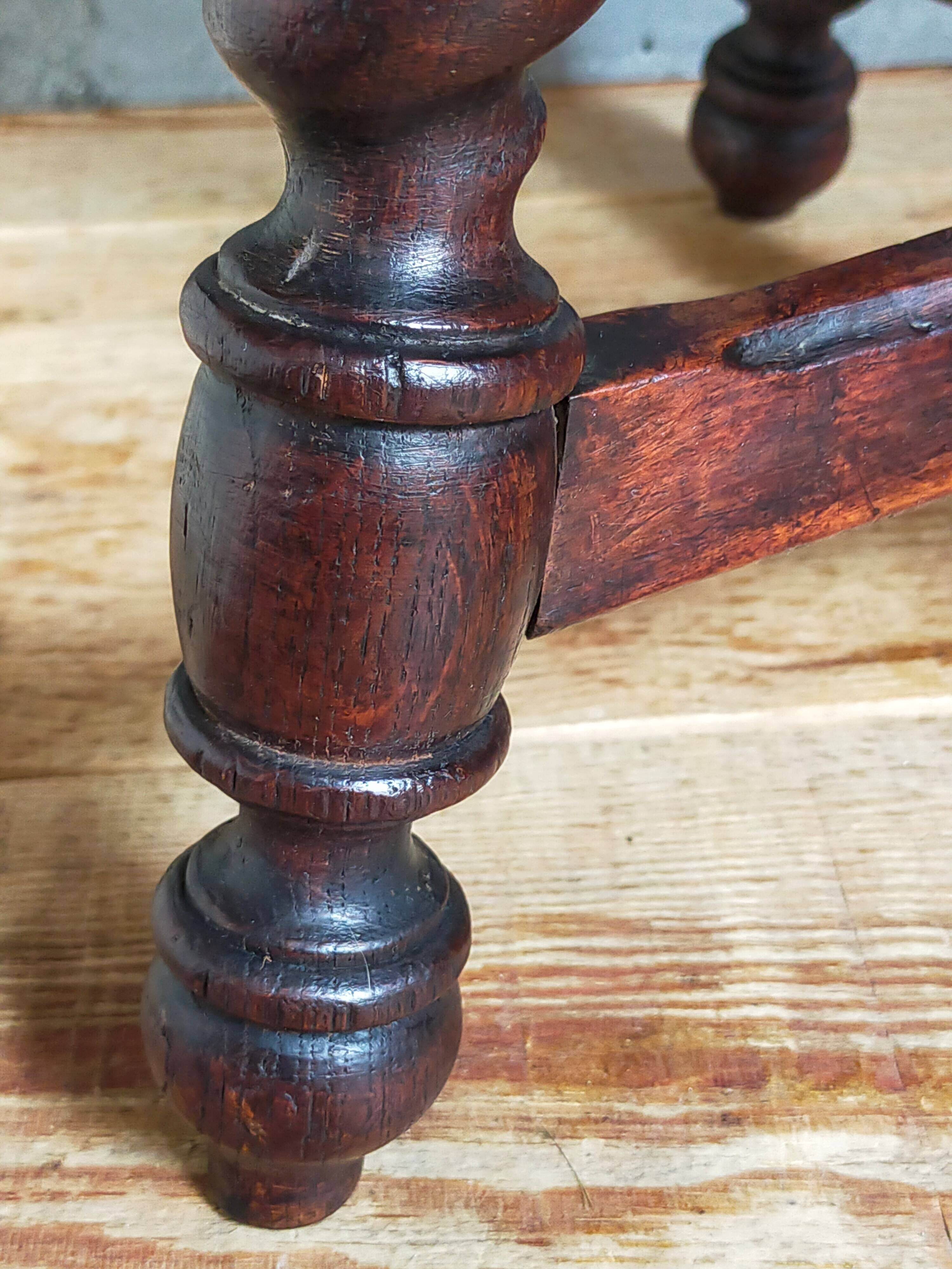 Antique stool in turned and carved solid wood