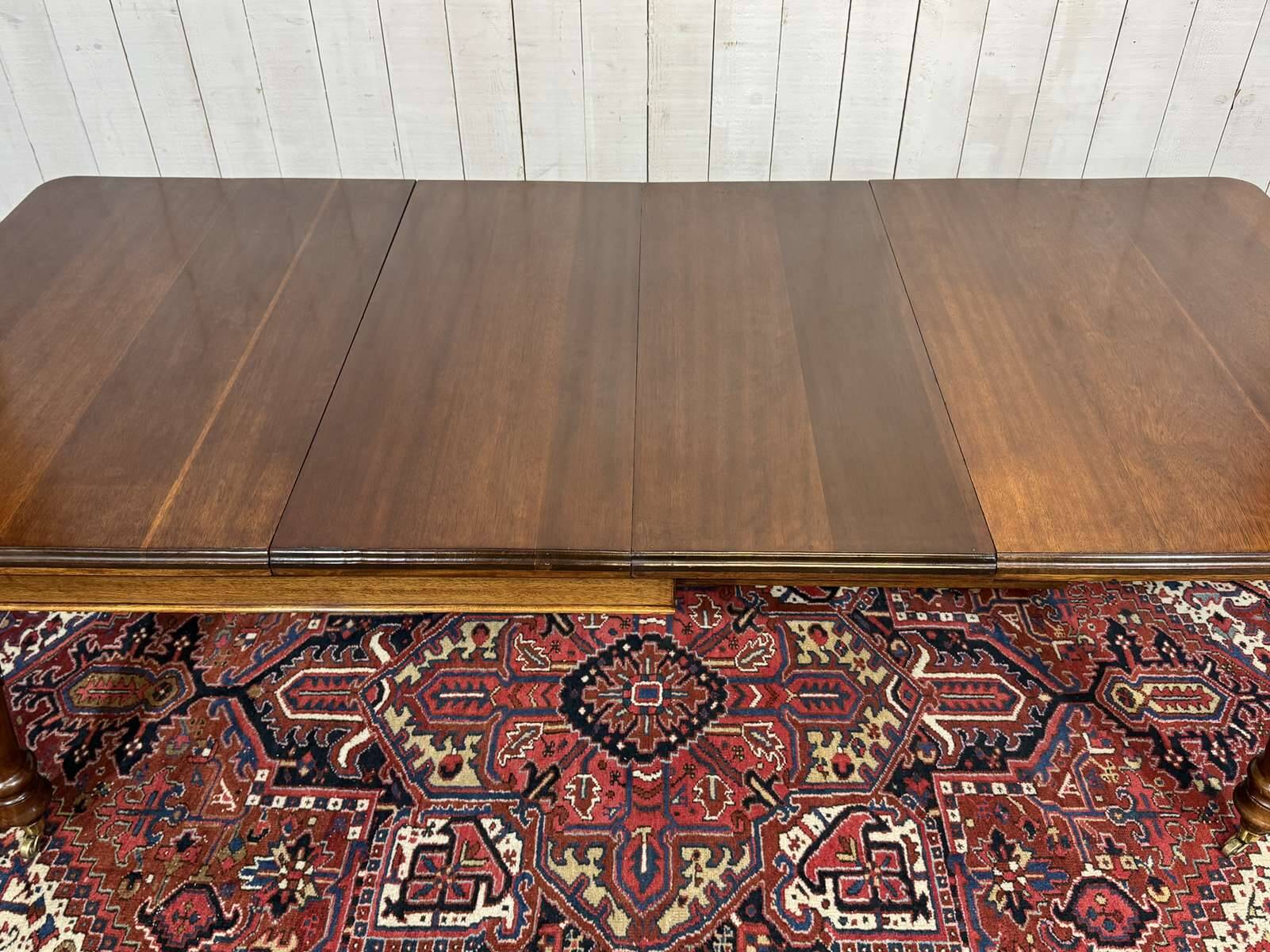 Victorian-style mahogany English table with 3 extensions.