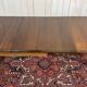 Victorian-style mahogany English table with 3 extensions.