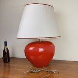 large vintage ceramic lamp with flower decorations on a red background circa 1980