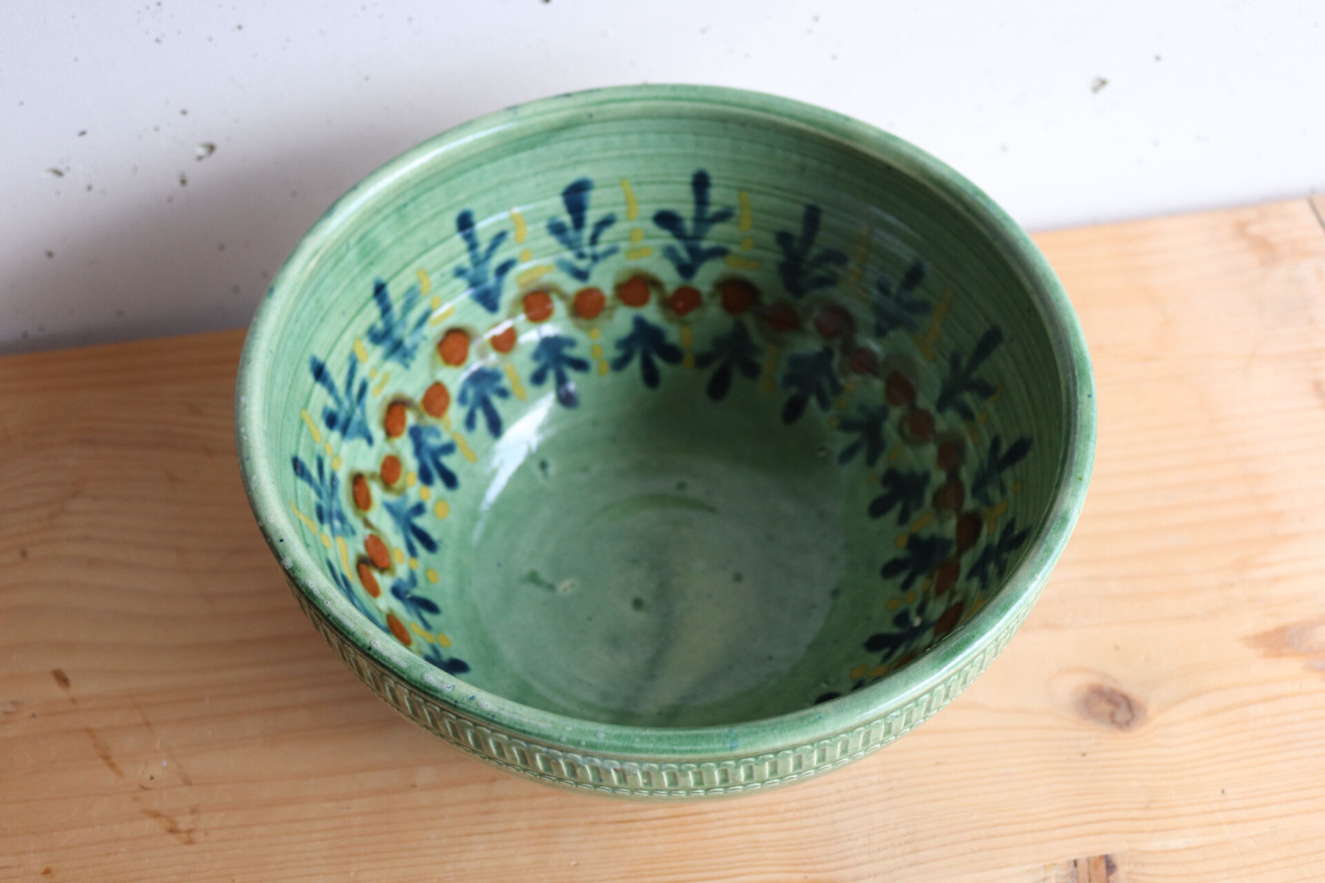 Large glazed ceramic salad bowl with a floral design.