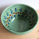 Large glazed ceramic salad bowl with a floral design.