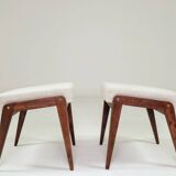 Pair of wooden stools with beige fabric.