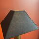 Brass shell socket lamp from the 1st WW, black pyramidal lampshade in Carlucci linen.