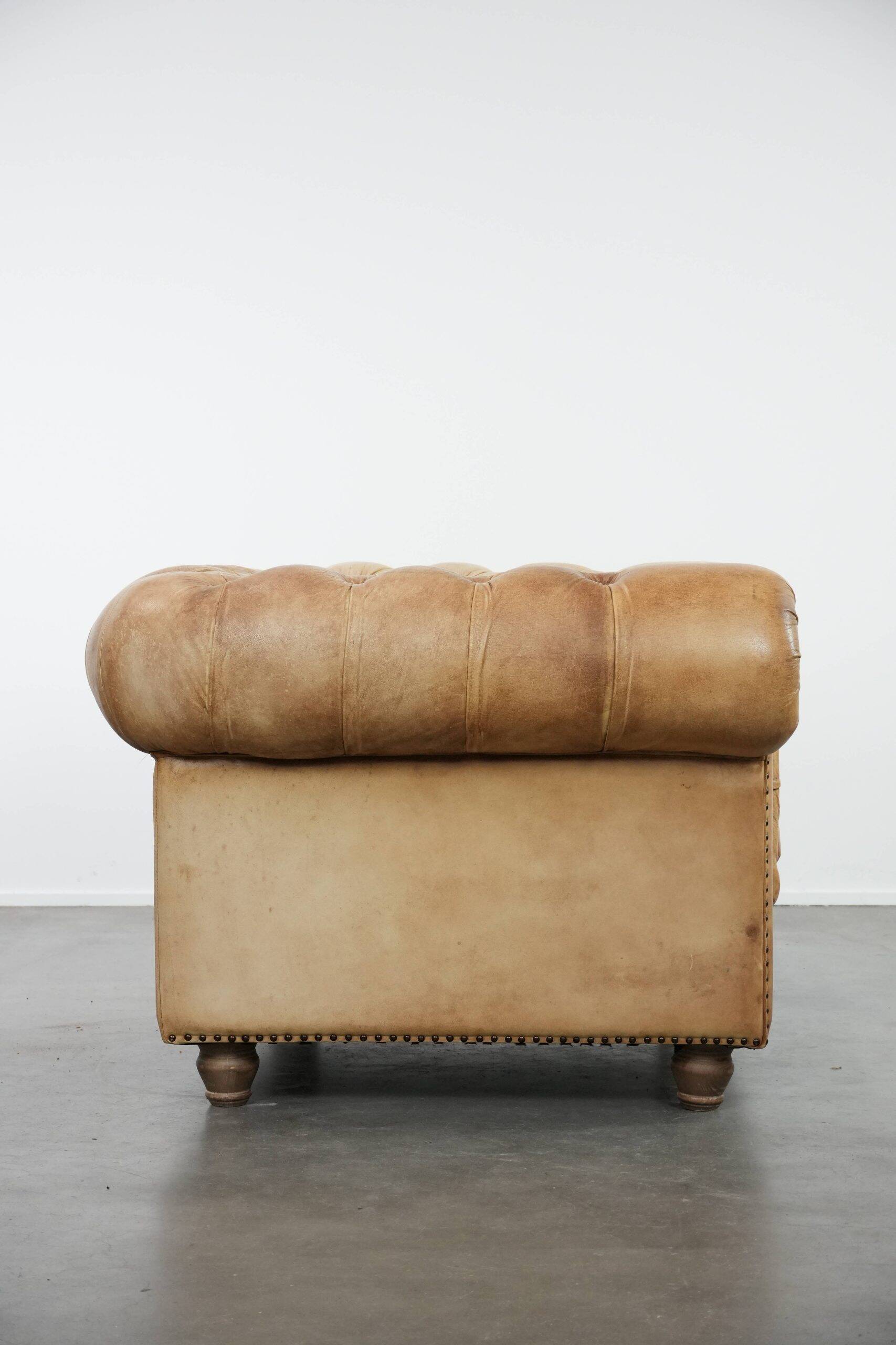 Chesterfield armchair made of cowhide leather in a light cognac colour