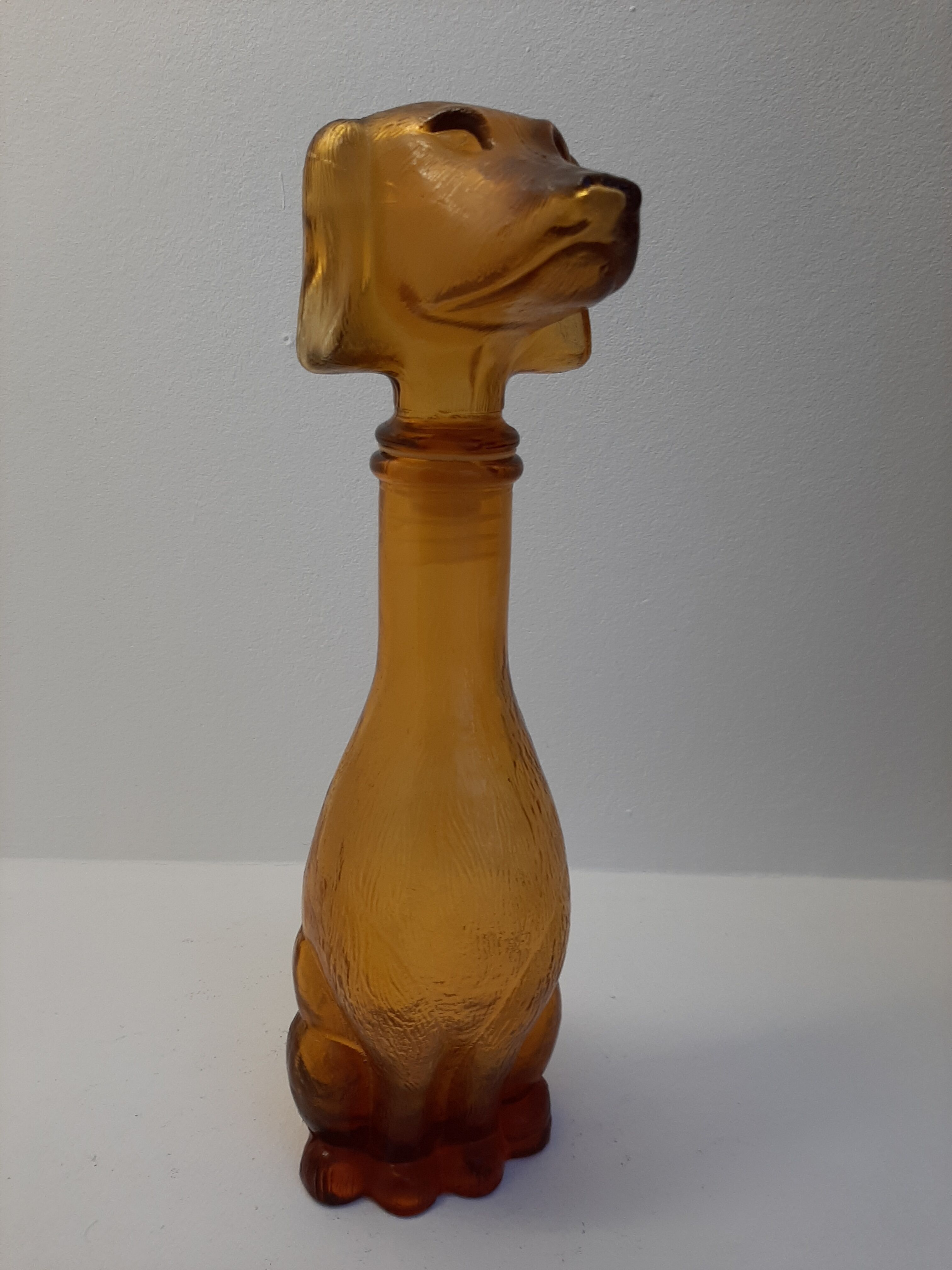 Amber glass bottle representing a dog, Empoli Italy 60s