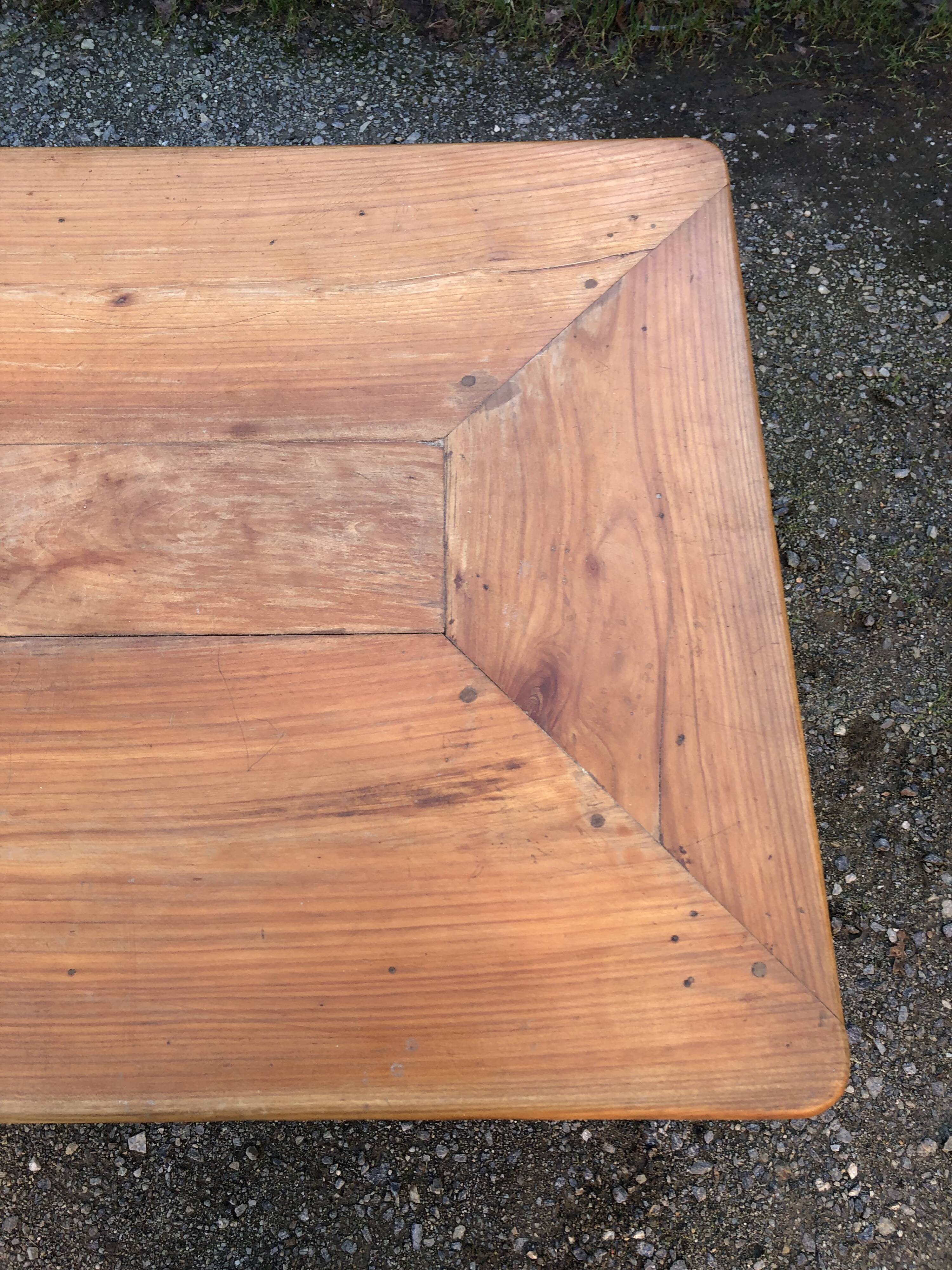 Antique cherry farmhouse table with turned legs and 2 drawers.