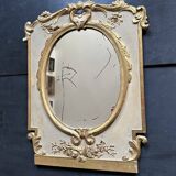 Napoleon III mirror in carved gilded wood, oval mercury glass.