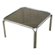 Table basse design vintage en verre fumé avec structure tubulaire