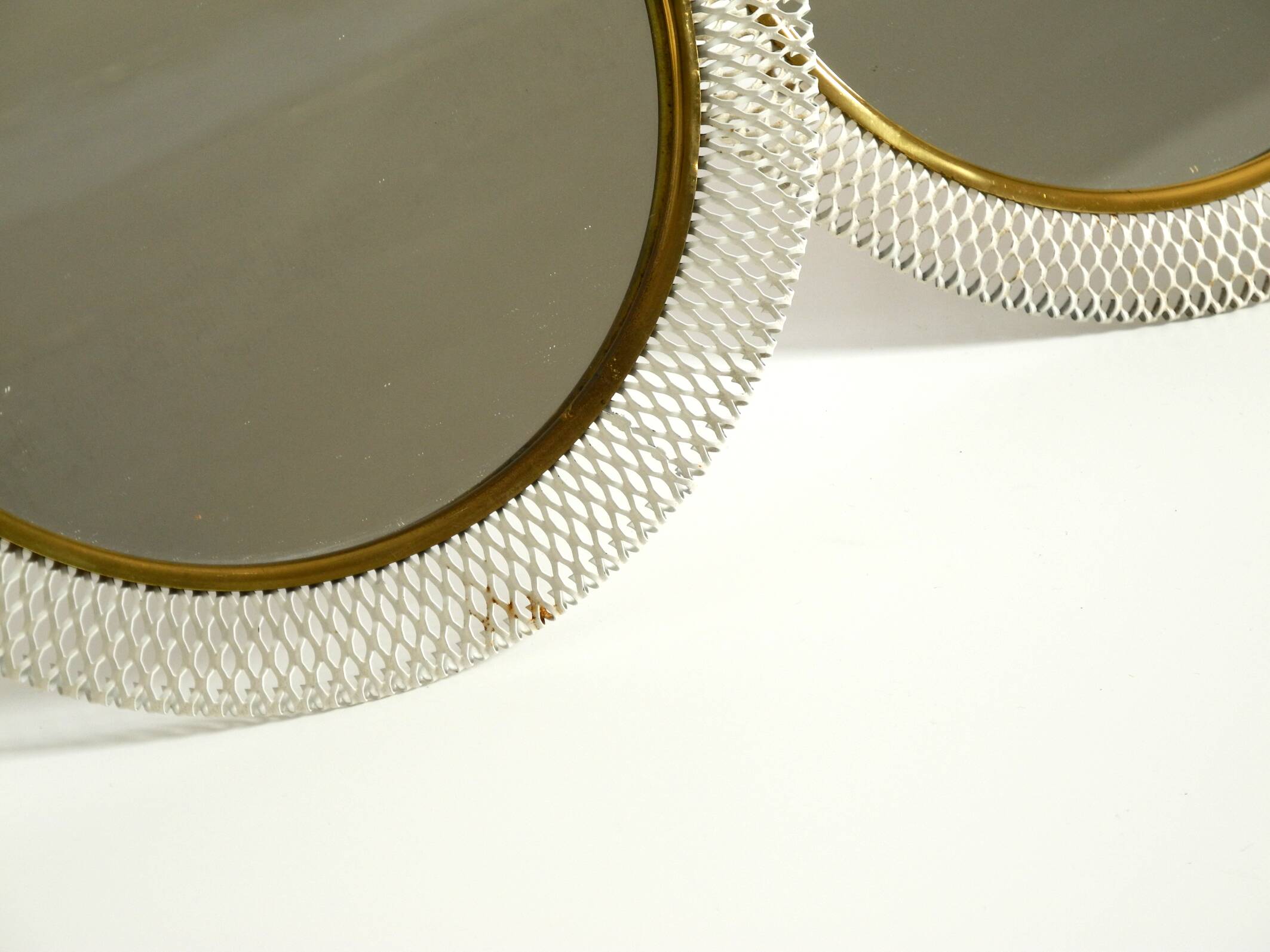 Pair of rare small Mid Century Modern table mirrors with expanded metal fra