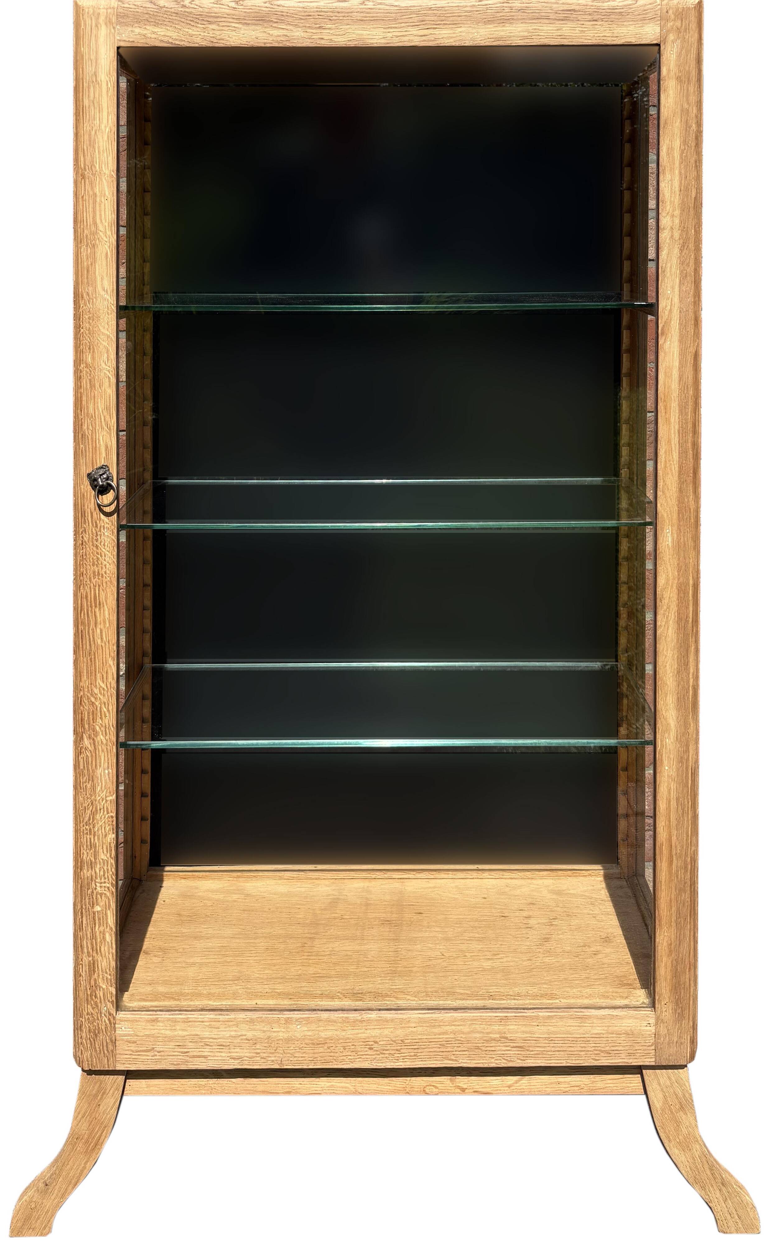 Restored antique oak display cabinet, black background, glass shelves.