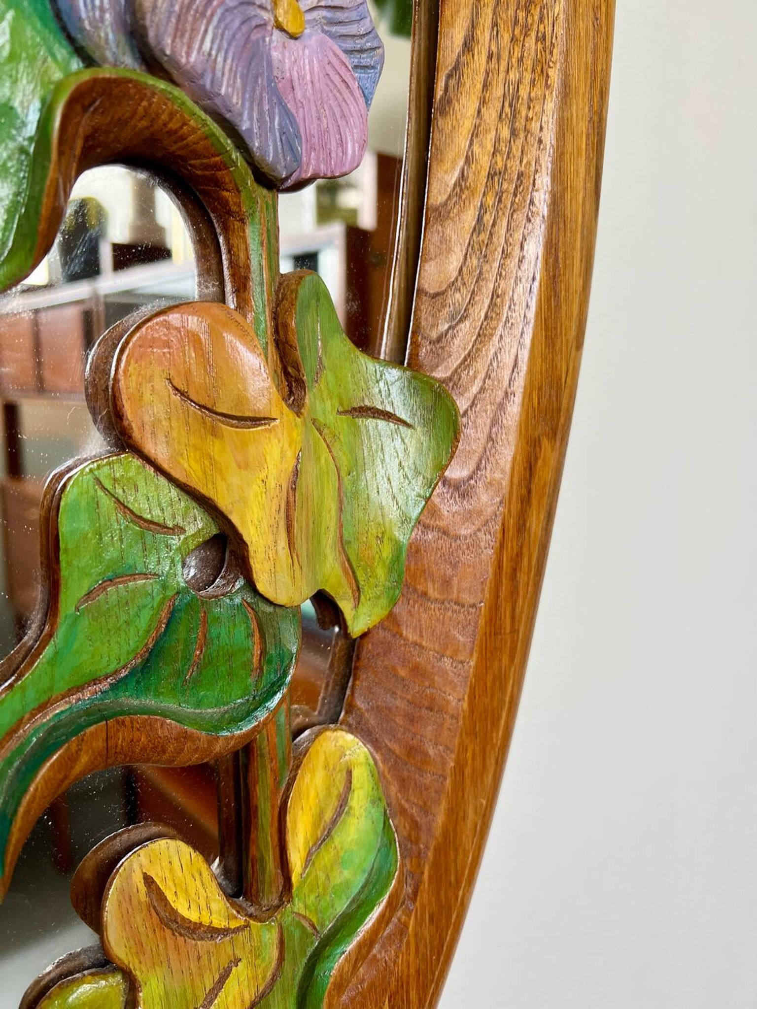 Carved wooden mirror with flower decorations.