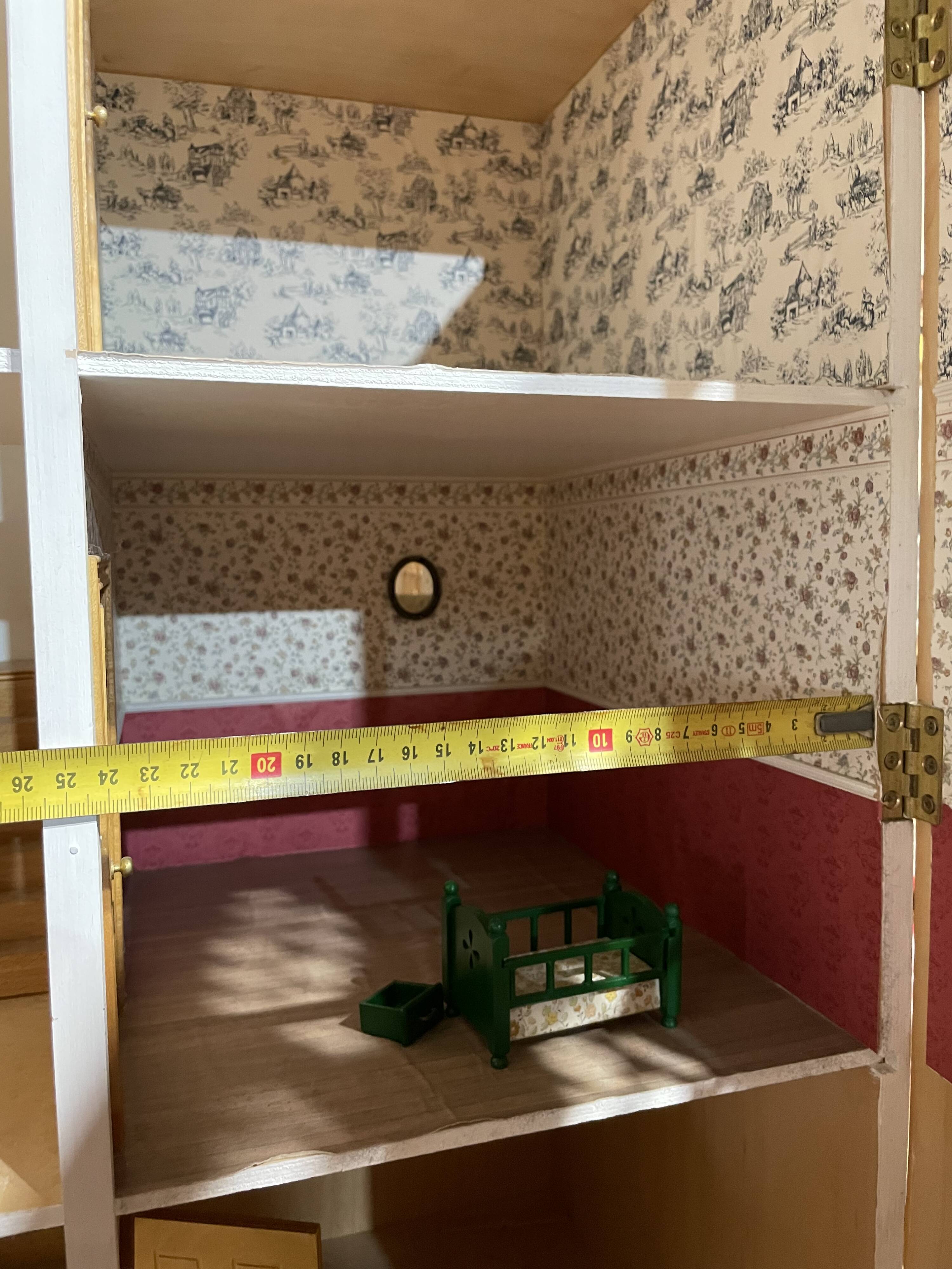 Large wooden dollhouse with miniature furniture