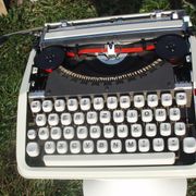 Baby hermes typewriter with manual job and his bag