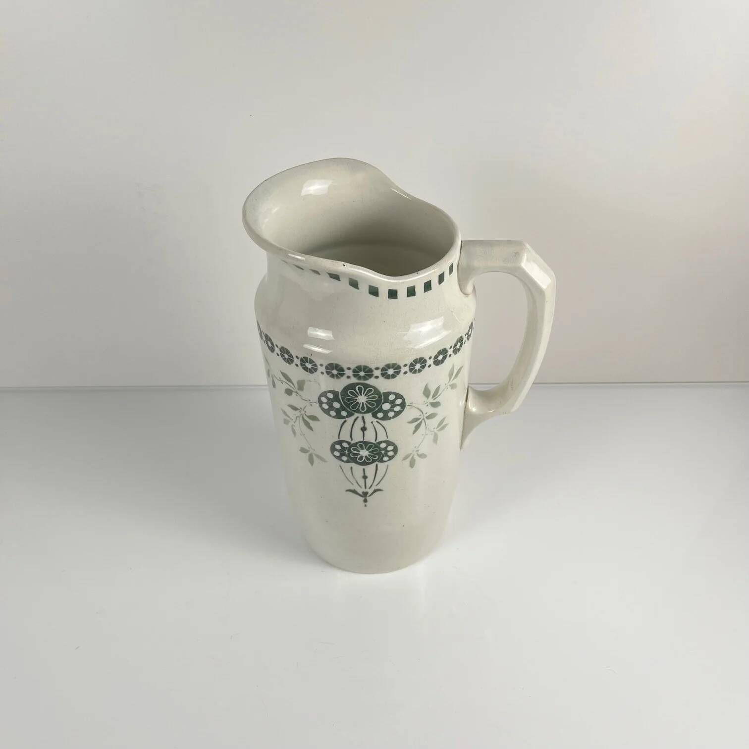 Antique earthenware pitcher, green floral decoration, fine ironstone from the late 19th to early 20th century.
