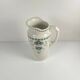 Antique earthenware pitcher, green floral decoration, fine ironstone from the late 19th to early 20th century.