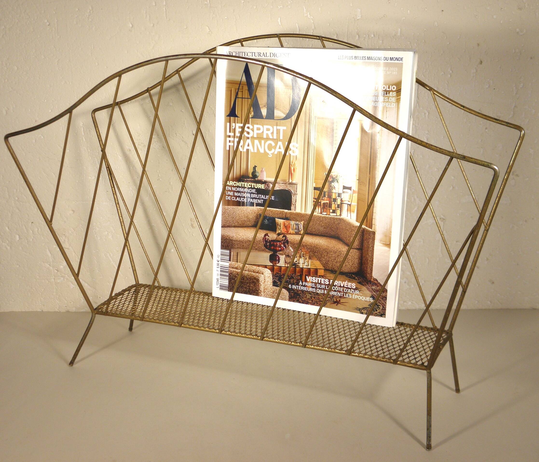 Golden metal magazine rack from the 60s